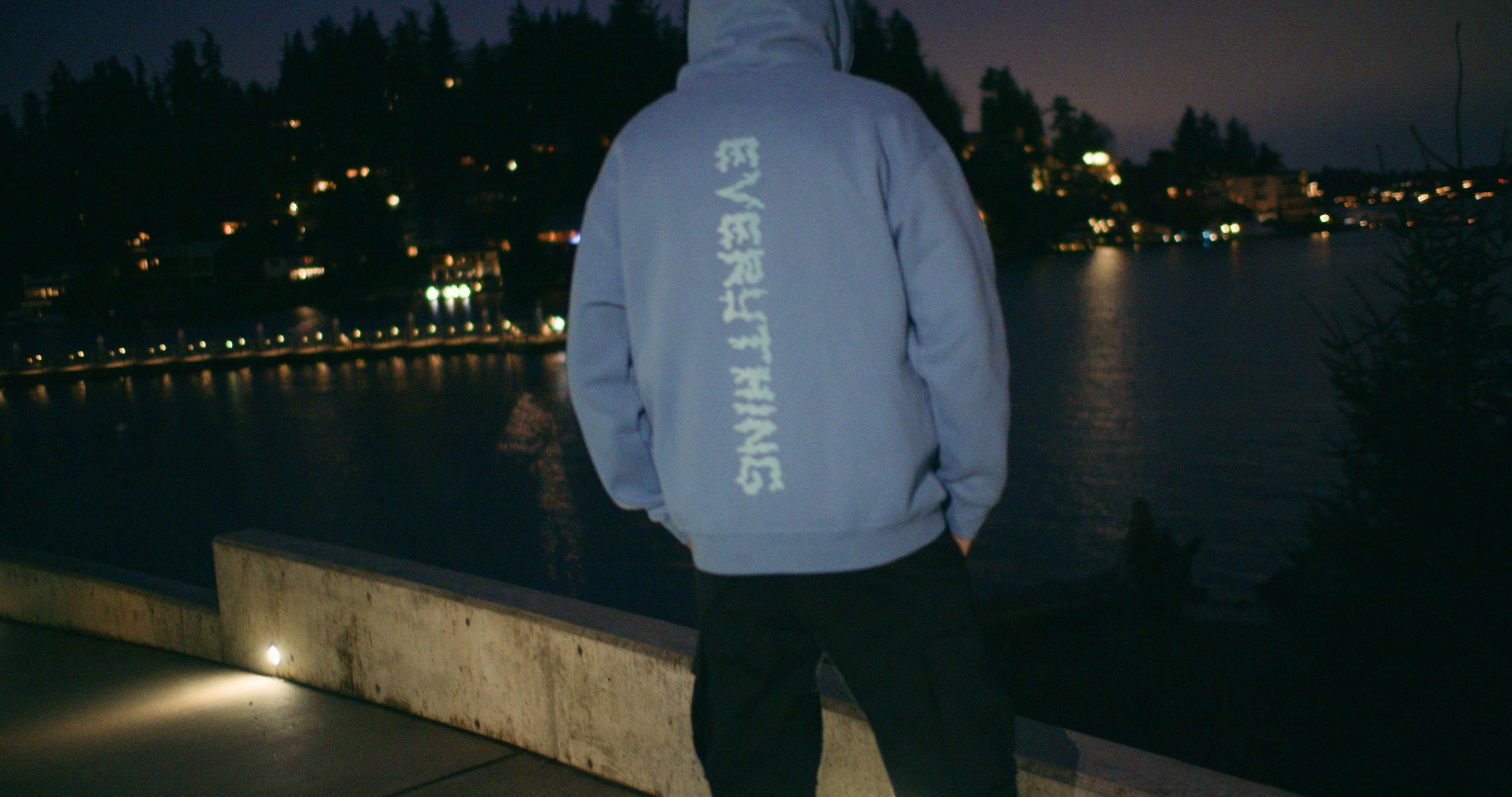 man with back turned in blue hoodie